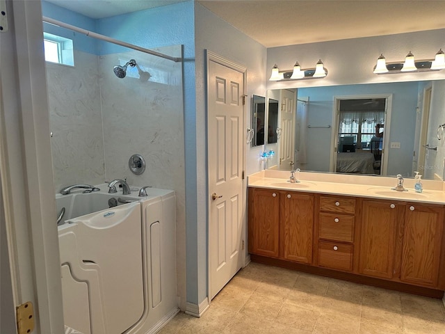 bathroom with vanity and independent shower and bath