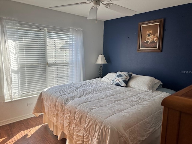 bedroom with hardwood / wood-style flooring and ceiling fan