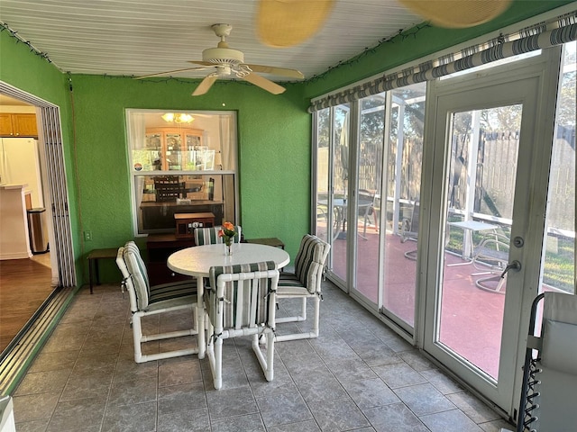 sunroom with ceiling fan and a healthy amount of sunlight