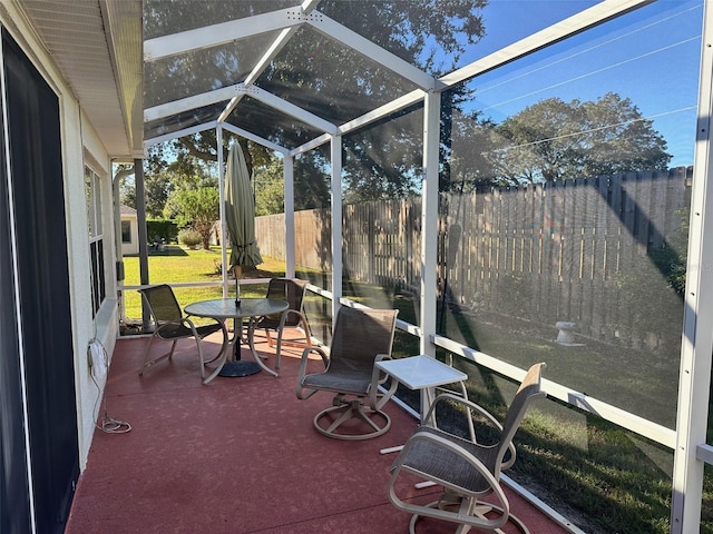 sunroom / solarium featuring lofted ceiling