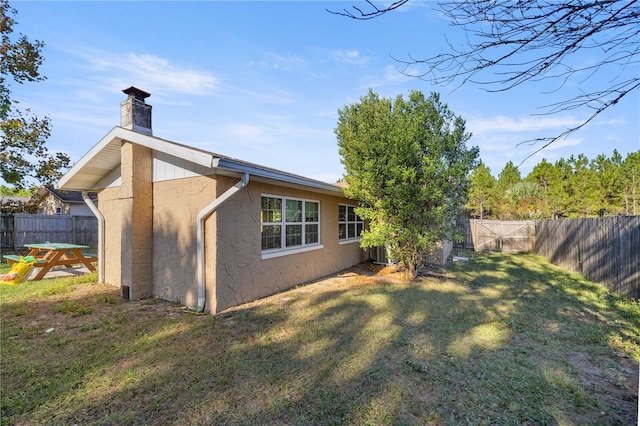 rear view of property featuring a yard and cooling unit