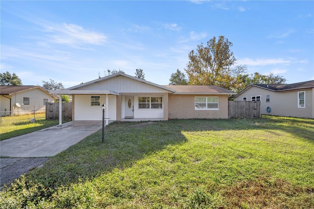 ranch-style house featuring a carport and a front lawn