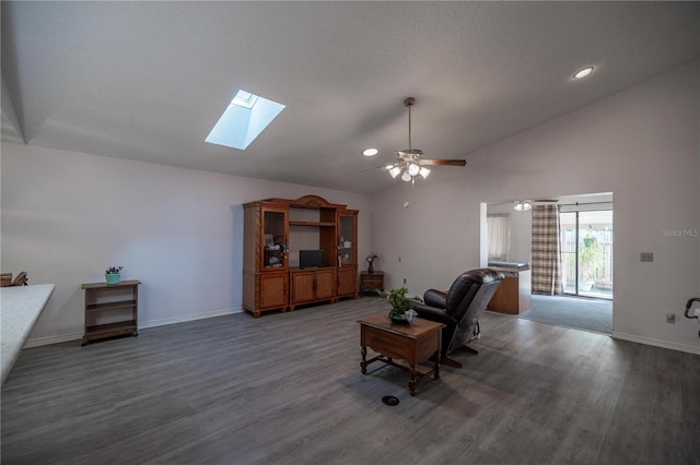 living room with ceiling fan, dark hardwood / wood-style flooring, high vaulted ceiling, and a skylight