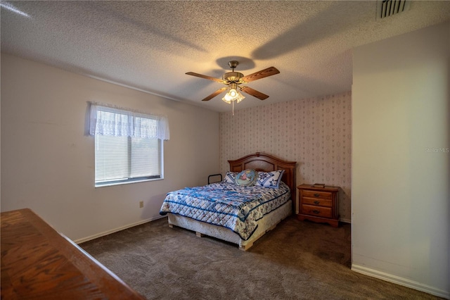 carpeted bedroom with ceiling fan and a textured ceiling