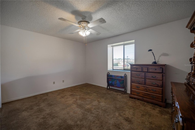 unfurnished bedroom featuring ceiling fan, a textured ceiling, and dark colored carpet