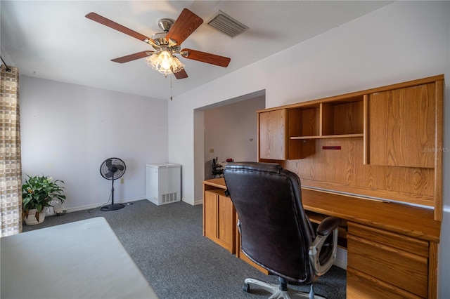 home office with dark colored carpet and ceiling fan