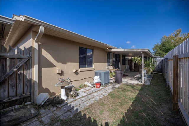 back of property with a patio and central AC unit