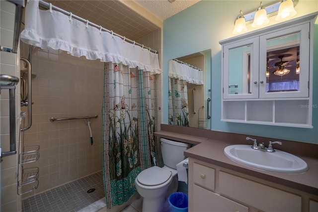 bathroom with toilet, a textured ceiling, walk in shower, ceiling fan, and vanity