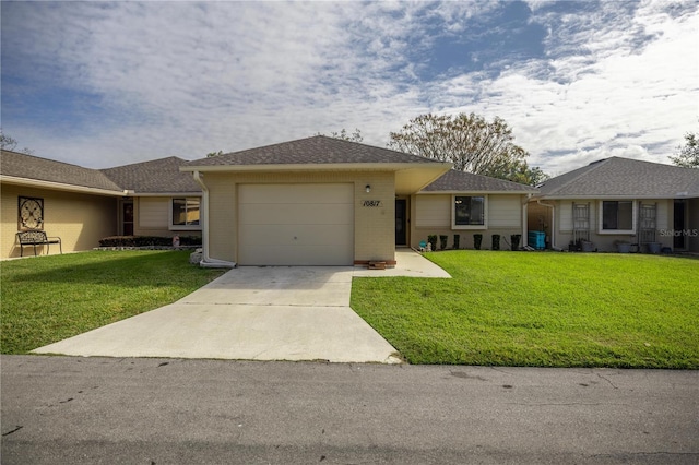 ranch-style home with driveway, a front lawn, a shingled roof, a garage, and brick siding