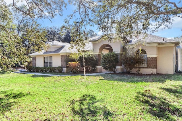 ranch-style home featuring a front yard