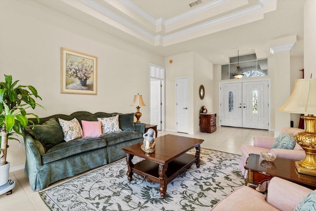 living room featuring a towering ceiling, a tray ceiling, ornamental molding, and light tile patterned flooring