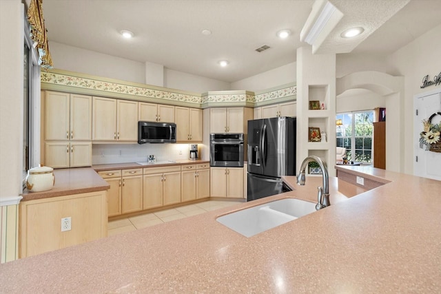 kitchen featuring appliances with stainless steel finishes, tasteful backsplash, light tile patterned floors, and sink