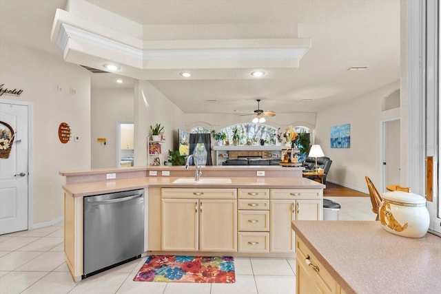 kitchen with light brown cabinetry, ceiling fan, sink, dishwasher, and light tile patterned flooring