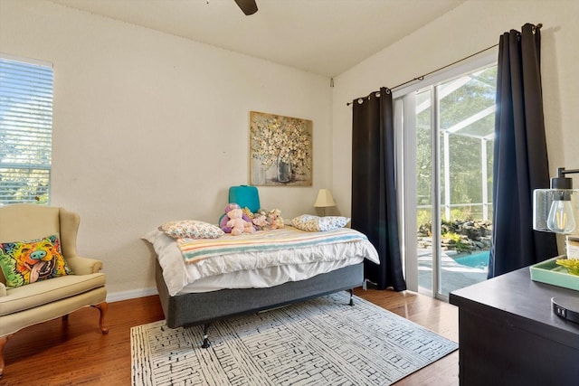 bedroom with access to outside, ceiling fan, and light wood-type flooring