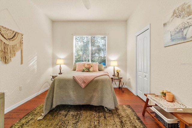 bedroom featuring ceiling fan, wood-type flooring, and a closet