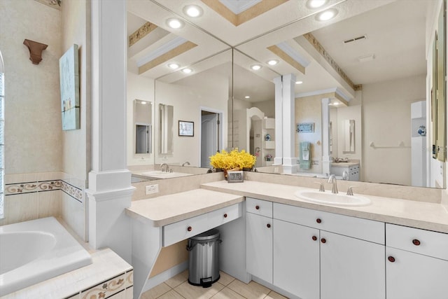 bathroom with tile patterned floors, vanity, tiled bath, and decorative columns