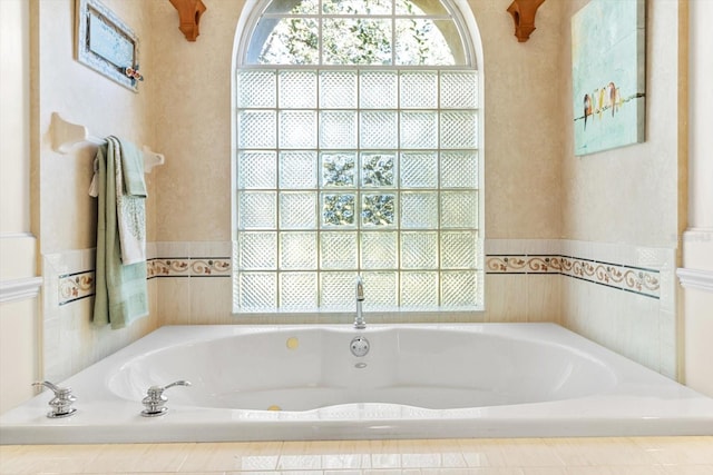 bathroom featuring tiled bath