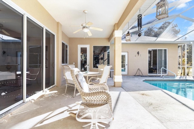 view of pool with a patio, ceiling fan, and a lanai