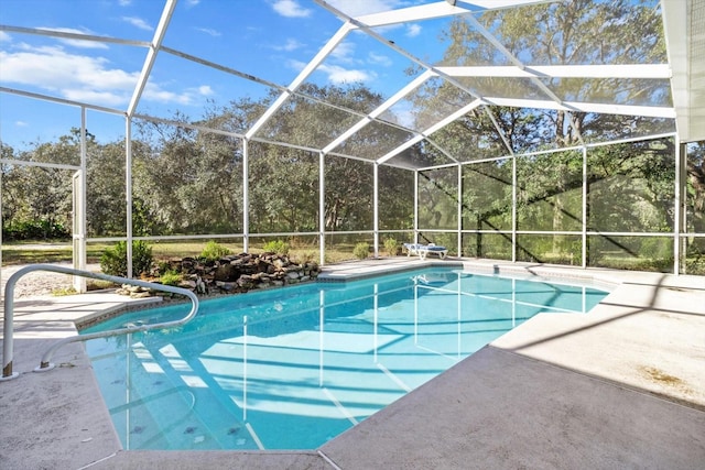 view of swimming pool featuring a patio area and a lanai