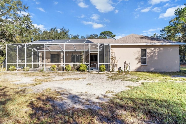 rear view of house featuring glass enclosure