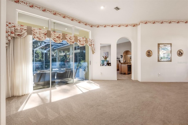 empty room with light carpet and a wealth of natural light