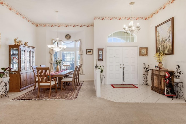 carpeted dining area featuring a chandelier