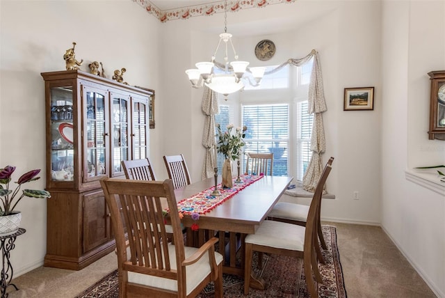 dining area featuring carpet floors and a notable chandelier