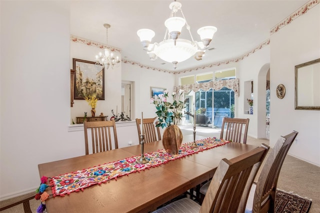 dining space featuring carpet flooring and an inviting chandelier