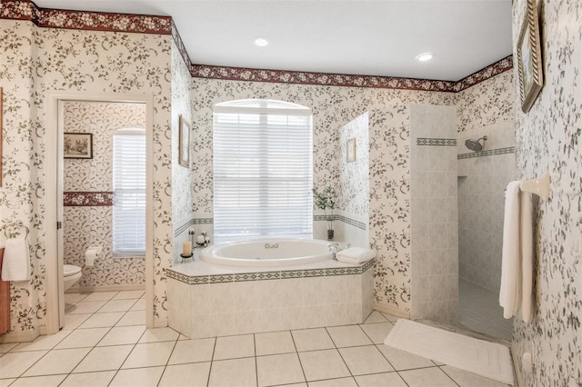 bathroom featuring toilet, tile patterned floors, and independent shower and bath