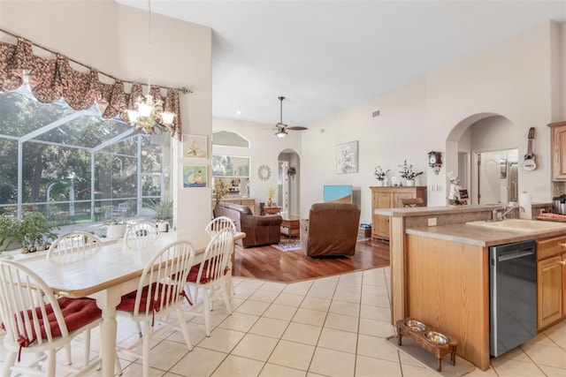 kitchen with ceiling fan, sink, dishwasher, hanging light fixtures, and light wood-type flooring