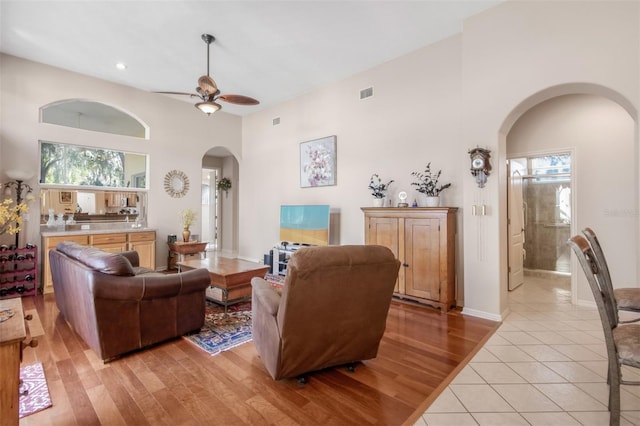 living room with light hardwood / wood-style floors and ceiling fan