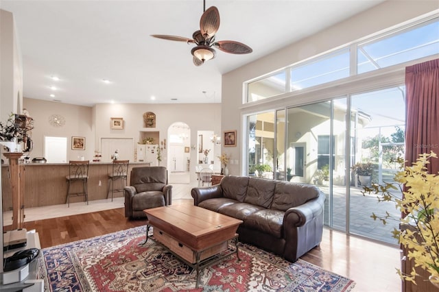 living room with hardwood / wood-style floors, ceiling fan, and a wealth of natural light