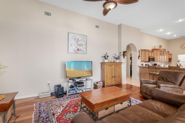 living room with ceiling fan and light hardwood / wood-style flooring