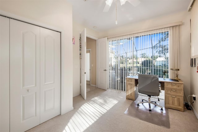 office area featuring ceiling fan and light colored carpet