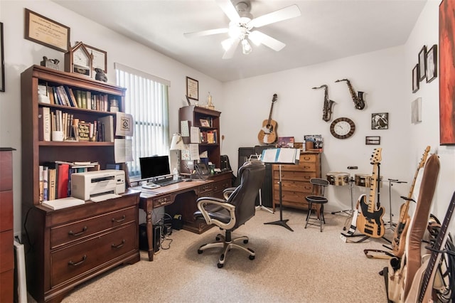 carpeted office space featuring ceiling fan