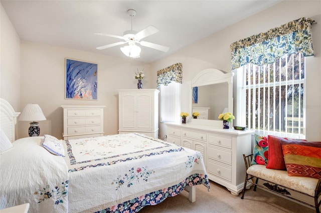 bedroom featuring ceiling fan and light carpet