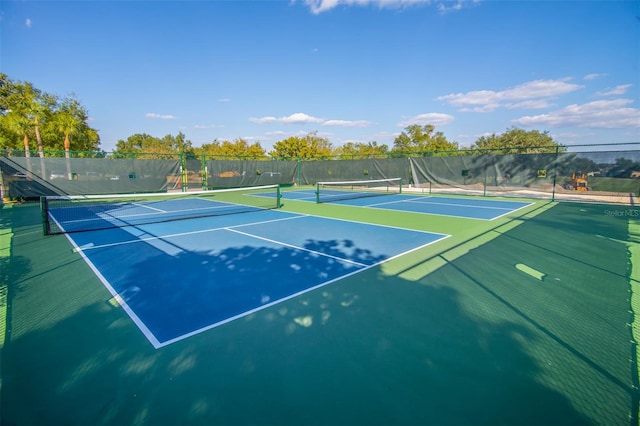 view of tennis court with basketball hoop