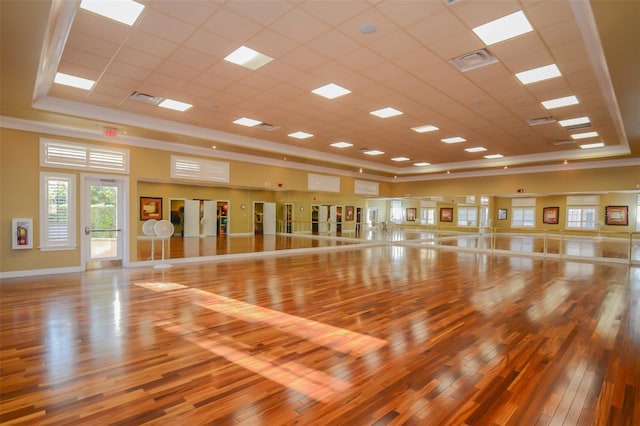 workout area with hardwood / wood-style flooring and a paneled ceiling