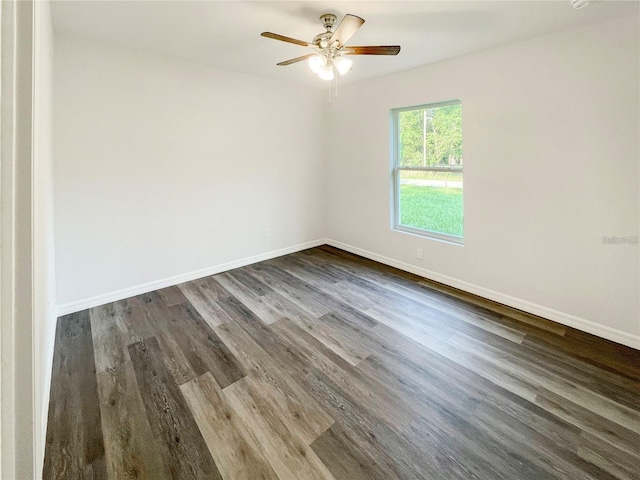 spare room featuring ceiling fan and dark hardwood / wood-style flooring