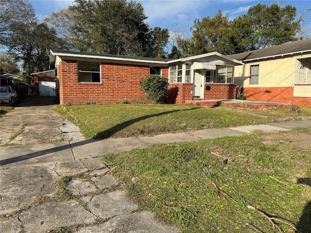 single story home with a front yard and a carport