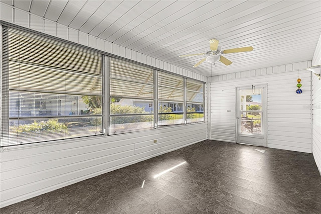 unfurnished sunroom featuring ceiling fan and wood ceiling