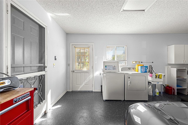 laundry room featuring washing machine and dryer and a textured ceiling