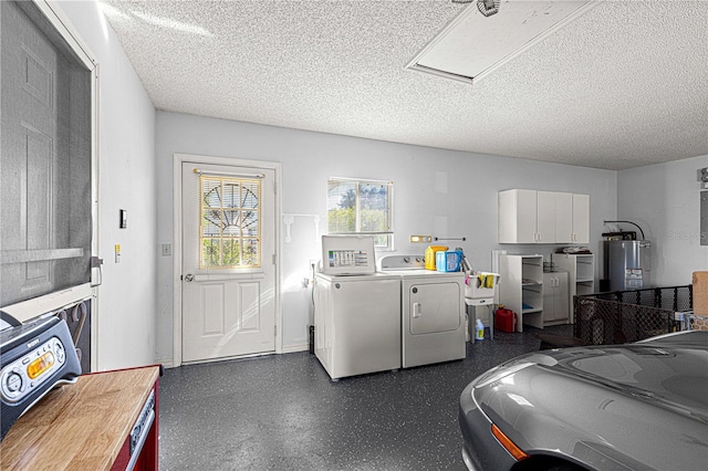 laundry area featuring gas water heater, washer and clothes dryer, and a textured ceiling