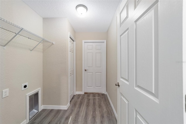 washroom with laundry area, baseboards, wood finished floors, a textured ceiling, and hookup for an electric dryer