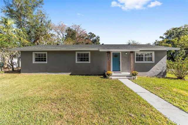 single story home featuring a front lawn