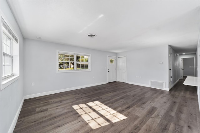 spare room featuring dark wood-type flooring