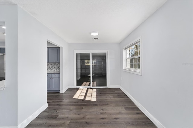 hallway featuring dark hardwood / wood-style flooring