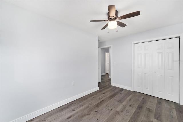 unfurnished bedroom featuring dark hardwood / wood-style flooring, a closet, and ceiling fan