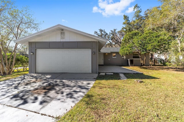 single story home with a garage and a front lawn