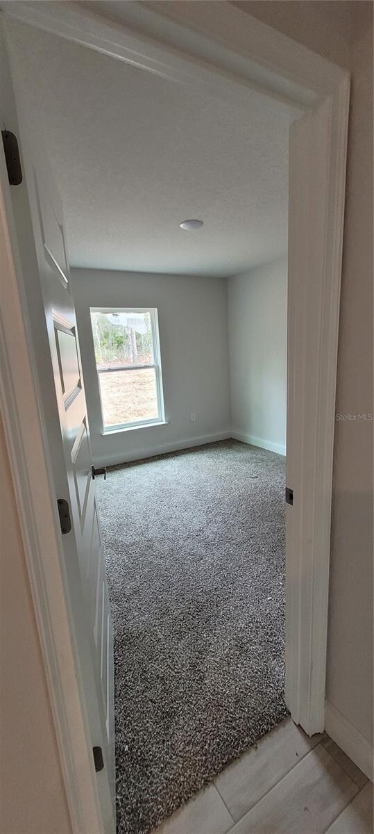 unfurnished room featuring light wood-style floors and baseboards